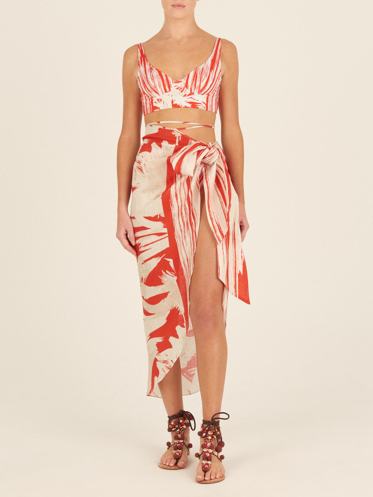 A Alice Skirt Coral Red Palm Print with a bow on it.