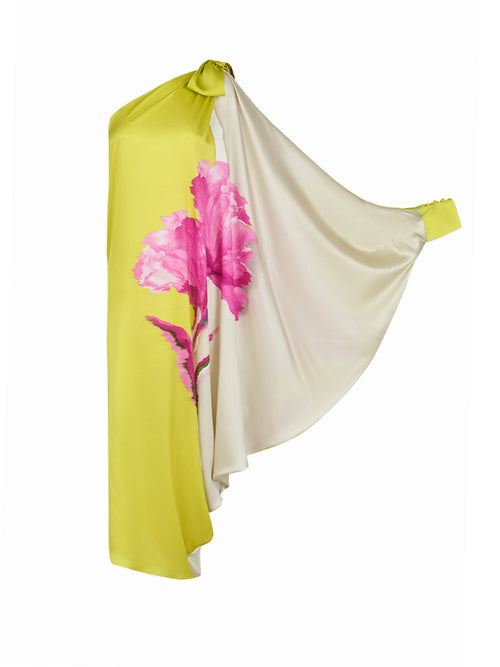 The Crema Tunic Chartreuse Beige Floral is a one-shoulder, asymmetrical silk tunic adorned with large pink floral prints and featuring a draped sleeve.