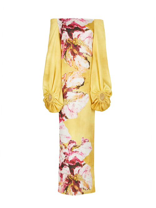 The Lexi Tunic, featuring a floral pattern with canary pink flowers, showcases an off-the-shoulder design and large, gathered sleeve details in yellow.