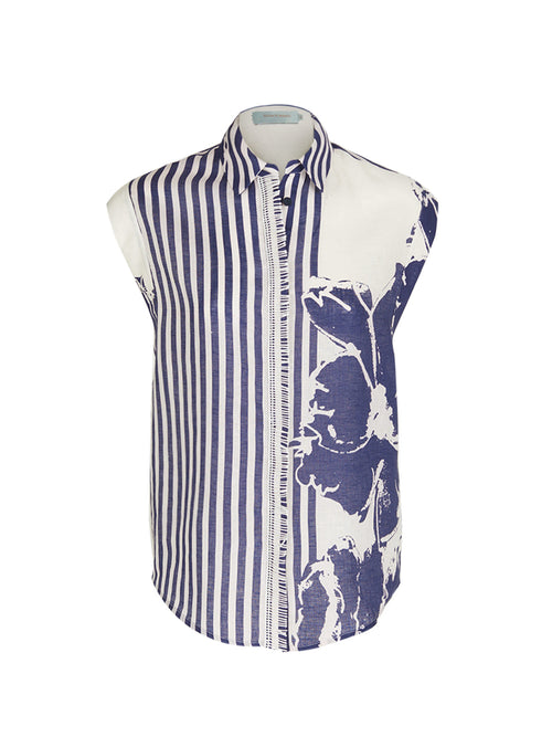 The Rina Blouse Azure Floral Stripes is a high fashion sleeveless shirt featuring vibrant azure floral stripes on the left side and a striking large blue floral pattern on the right side.