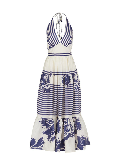 The Valerie Dress Azure Floral Stripes is a charming addition to your Spring 2023 wardrobe, featuring a sleeveless, halter-neck design with azure floral stripes and blue floral prints on the skirt and hemline.