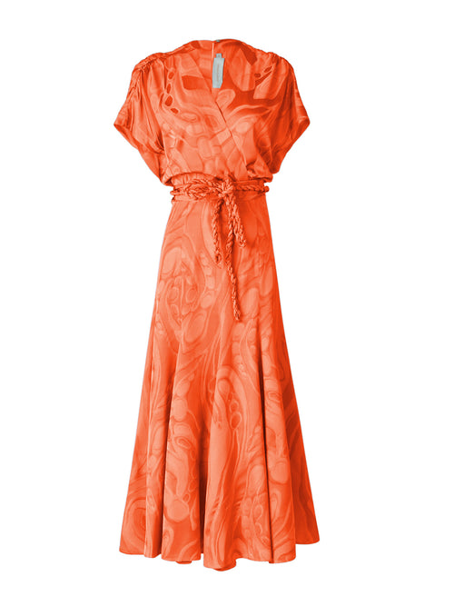 The Sottomarina Dress Orange Marble is an orange, short-sleeve, wrap-style dress with a tied waist and a flowing skirt, featuring a subtle textured marbled jacquard pattern.