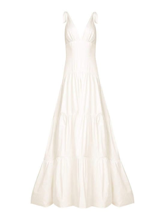 A Terracina Dress White with a V-neckline and a floor-length tiered skirt, making an elegant statement as the perfect formal dress.