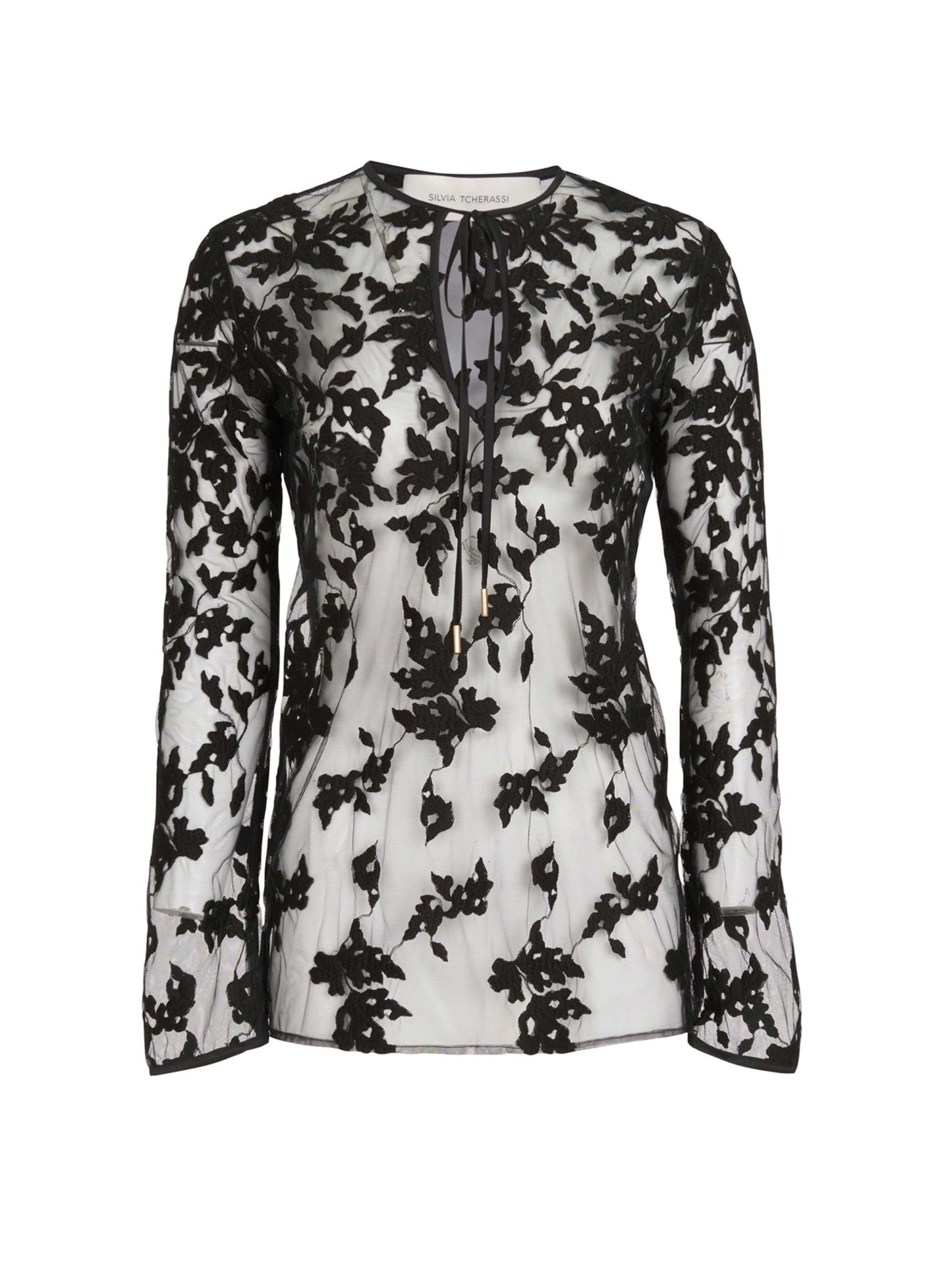 A long-sleeve, semi-sheer white Tosca Blouse Black Velvet featuring a black floral lace overlay and an abstract print keyhole tie neckline.