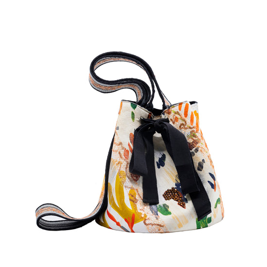 A white Mochila Laaput Black Multicolor handbag with a black hand-woven strap showcasing Wayuu craftsmanship.